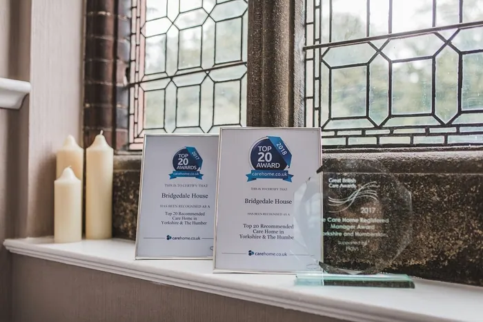 Top 20 carehome.co.uk award certificates on a windowsill