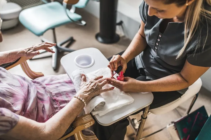 A resident's hands being cared for during a manicure